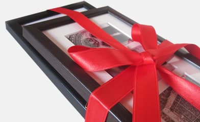 A framed photo word wrapped with a bow